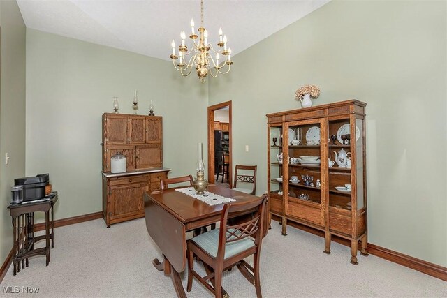 4255 River Rd, Perry, OH 44081 - dining space featuring light colored carpet, a chandelier, and baseboards