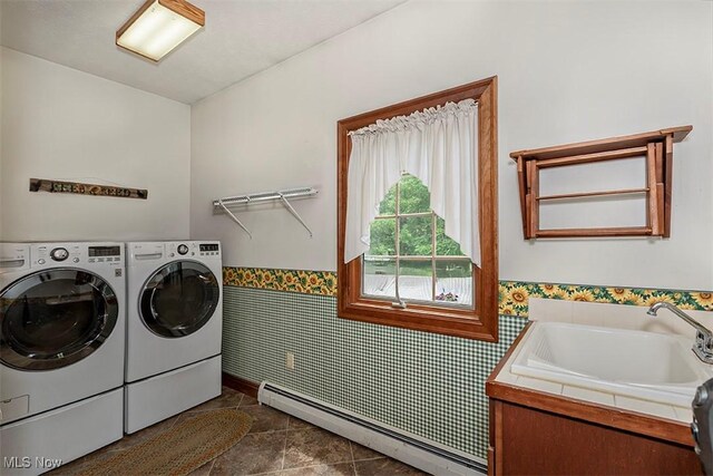 4255 River Rd, Perry, OH 44081 - washroom featuring washing machine and clothes dryer, wainscoting, a baseboard heating unit, dark tile patterned floors, and tile walls