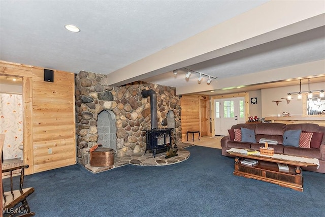4255 River Rd, Perry, OH 44081 - carpeted living area featuring a wood stove and wood walls