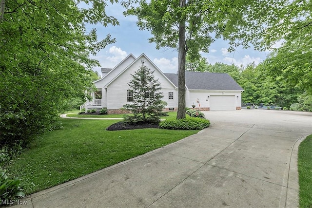 4255 River Rd, Perry, OH 44081 - view of front of house featuring concrete driveway, an attached garage, and a front yard
