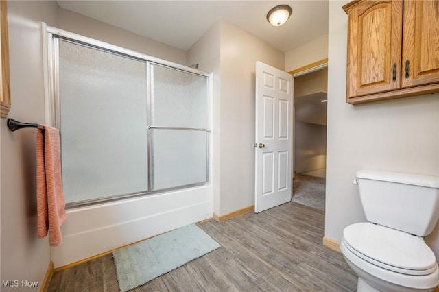 33992 Brwnsvl Co Line Rd, New Matamoras, OH 45767 - full bathroom with wood finished floors, baseboards, enclosed tub / shower combo, and toilet