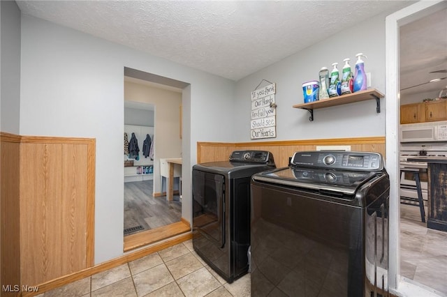 33992 Brwnsvl Co Line Rd, New Matamoras, OH 45767 - washroom featuring washer and dryer, a textured ceiling, and light tile patterned floors