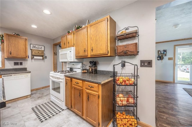 33992 Brwnsvl Co Line Rd, New Matamoras, OH 45767 - kitchen featuring white appliances, baseboards, recessed lighting, dark countertops, and brown cabinets