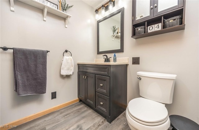33992 Brwnsvl Co Line Rd, New Matamoras, OH 45767 - half bath with wood finished floors, toilet, vanity, and baseboards