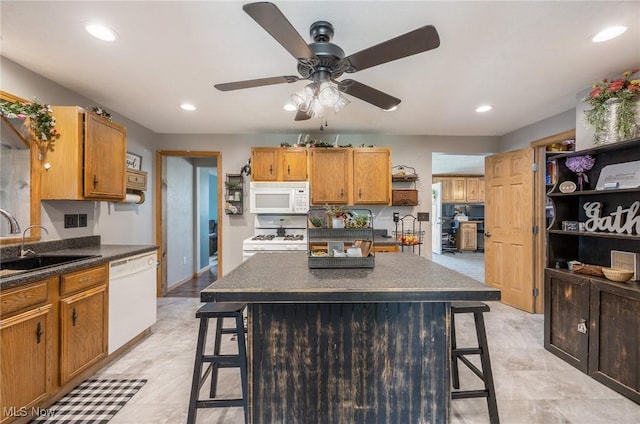 33992 Brwnsvl Co Line Rd, New Matamoras, OH 45767 - kitchen with white appliances, a kitchen bar, dark countertops, and recessed lighting