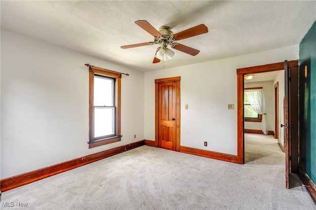 100 Byers Ave, Akron, OH 44302 - unfurnished room with light carpet, baseboards, plenty of natural light, and a textured ceiling