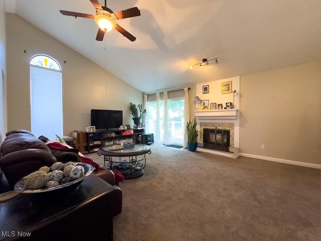 6647 Avalon St NW, Canton, OH 44708 - carpeted living room with healthy amount of natural light, a ceiling fan, a stone fireplace, high vaulted ceiling, and baseboards