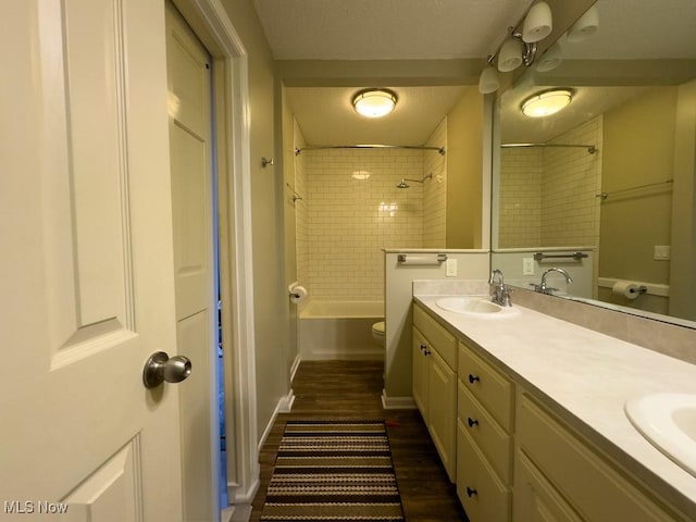 6647 Avalon St NW, Canton, OH 44708 - bathroom with double vanity, wood finished floors, shower / washtub combination, toilet, and baseboards
