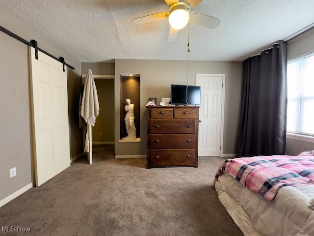 6647 Avalon St NW, Canton, OH 44708 - carpeted bedroom featuring a barn door, a textured ceiling, baseboards, and ceiling fan