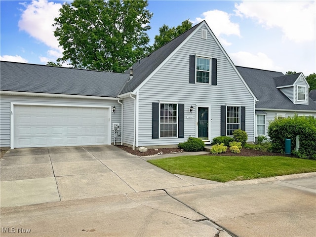 3430 E Prescott Cir, Cuyahoga Falls, OH 44223 - view of front of house with concrete driveway, a garage, and a front lawn
