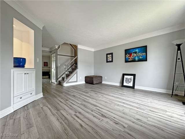 3430 E Prescott Cir, Cuyahoga Falls, OH 44223 - unfurnished living room with stairway, crown molding, wood finished floors, baseboards, and a textured ceiling
