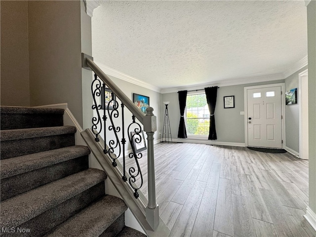 3430 E Prescott Cir, Cuyahoga Falls, OH 44223 - foyer featuring wood finished floors, crown molding, a textured ceiling, stairway, and baseboards