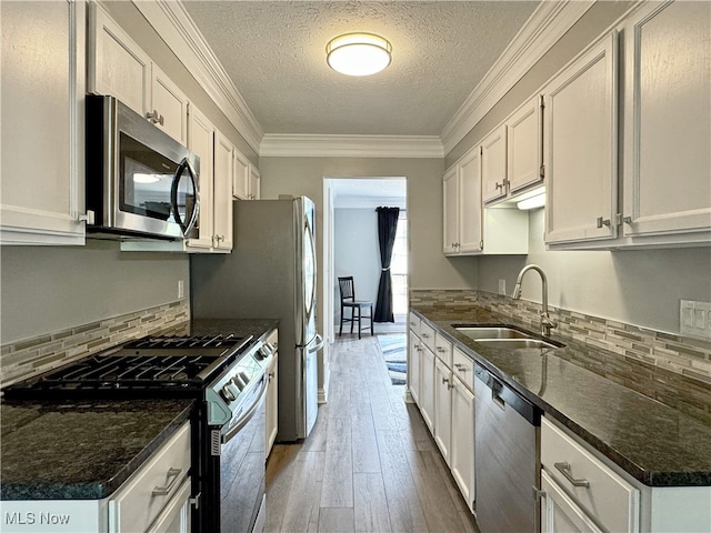 3430 E Prescott Cir, Cuyahoga Falls, OH 44223 - kitchen featuring stainless steel appliances, a sink, wood-type flooring, a textured ceiling, and decorative backsplash