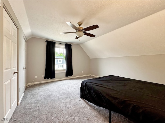 3430 E Prescott Cir, Cuyahoga Falls, OH 44223 - carpeted bedroom with vaulted ceiling, baseboards, a textured ceiling, and a ceiling fan