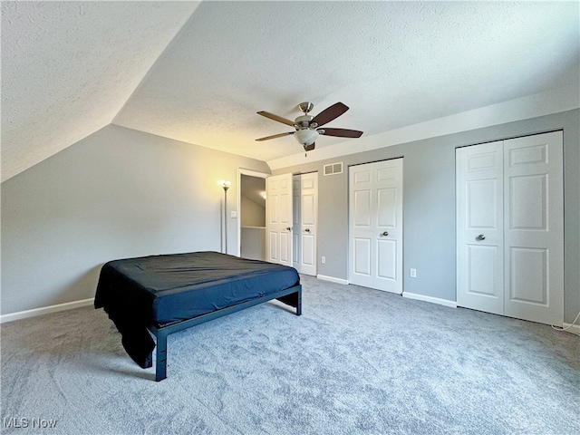 3430 E Prescott Cir, Cuyahoga Falls, OH 44223 - bedroom with a textured ceiling, carpet, multiple closets, baseboards, and lofted ceiling