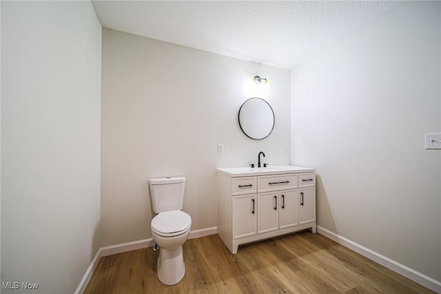 433 N Buckeye, Wooster, OH 44691 - bathroom featuring wood finished floors, vanity, toilet, and baseboards