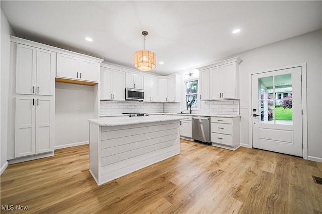 433 N Buckeye, Wooster, OH 44691 - kitchen with appliances with stainless steel finishes, decorative backsplash, white cabinets, light wood-type flooring, and recessed lighting