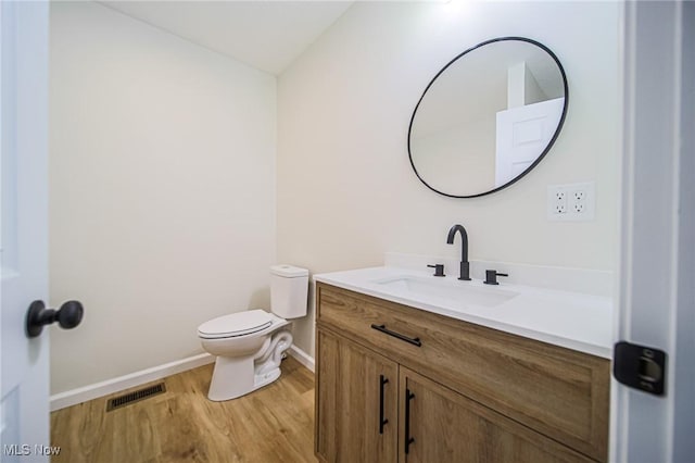 433 N Buckeye, Wooster, OH 44691 - bathroom featuring wood finished floors, vanity, toilet, and baseboards