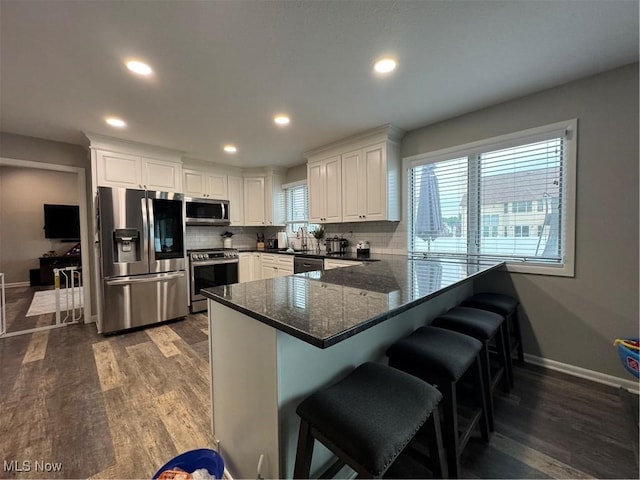 1470 Butterfield Cir, Niles, OH 44446 - kitchen featuring appliances with stainless steel finishes, dark wood-type flooring, recessed lighting, white cabinets, and baseboards