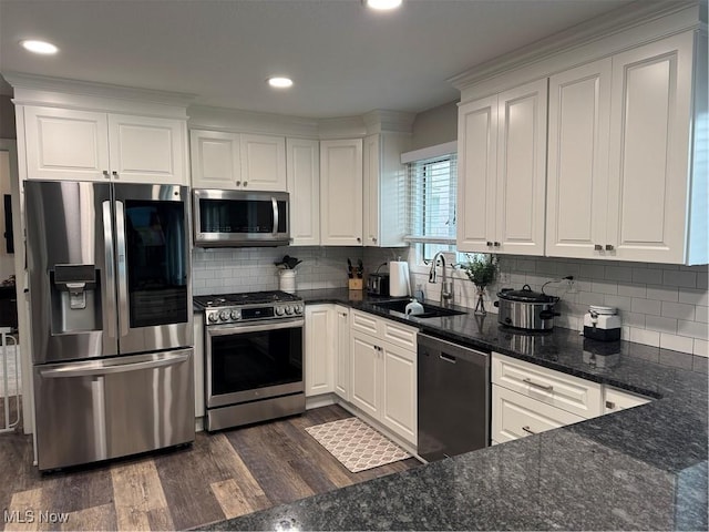 1470 Butterfield Cir, Niles, OH 44446 - kitchen featuring appliances with stainless steel finishes, a sink, white cabinetry, backsplash, and dark wood-style floors