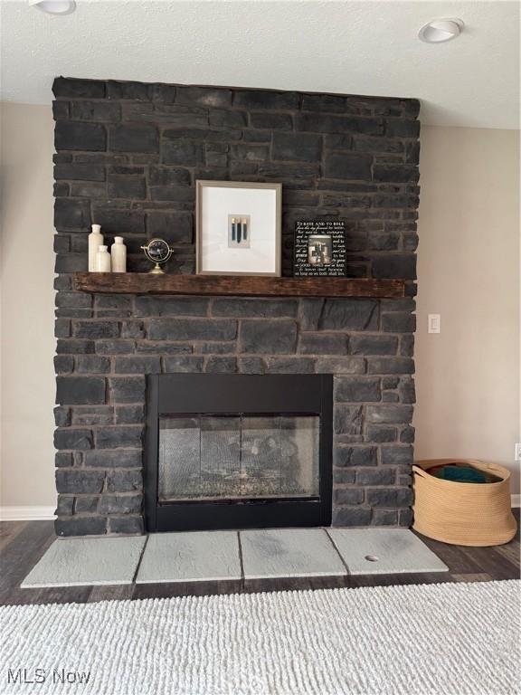 1470 Butterfield Cir, Niles, OH 44446 - detailed view of a stone fireplace, wood finished floors, and baseboards