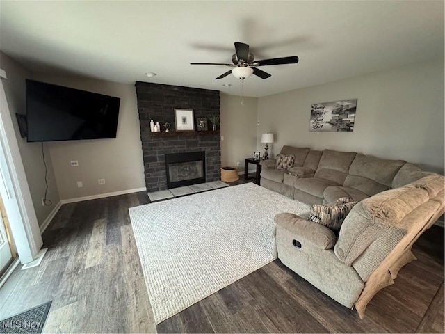1470 Butterfield Cir, Niles, OH 44446 - living area with dark wood finished floors, ceiling fan, a stone fireplace, and baseboards