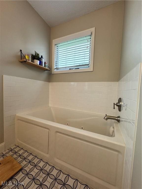 1470 Butterfield Cir, Niles, OH 44446 - bathroom with a tub with jets, tile patterned floors, and a textured ceiling