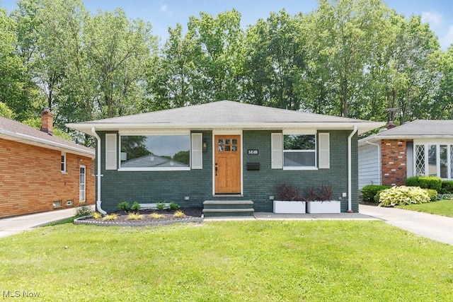 14148 Rochelle Dr, Maple Heights, OH 44137 - view of front facade with entry steps, a front lawn, and brick siding