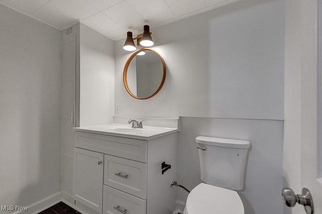 14148 Rochelle Dr, Maple Heights, OH 44137 - bathroom with vanity, toilet, ornamental molding, and baseboards