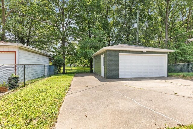 14148 Rochelle Dr, Maple Heights, OH 44137 - detached garage featuring view of scattered trees