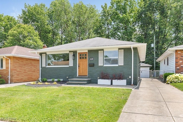 14148 Rochelle Dr, Maple Heights, OH 44137 - view of front of home with entry steps, brick siding, a front yard, and a chimney