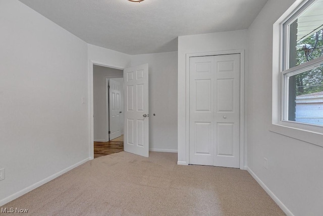 14148 Rochelle Dr, Maple Heights, OH 44137 - unfurnished bedroom with carpet flooring, baseboards, and a closet