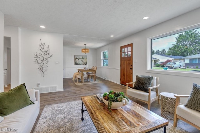 14148 Rochelle Dr, Maple Heights, OH 44137 - living area with a textured ceiling, wood finished floors, recessed lighting, a chandelier, and baseboards