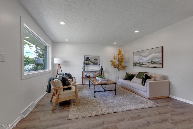 14148 Rochelle Dr, Maple Heights, OH 44137 - living room featuring a textured ceiling, wood finished floors, recessed lighting, and baseboards