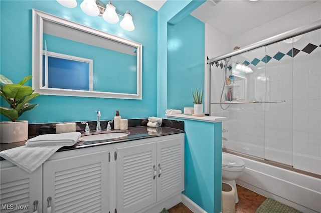 8222 Starburst Rd, Mentor, OH 44060 - bathroom with vanity, toilet, and combined bath / shower with glass door