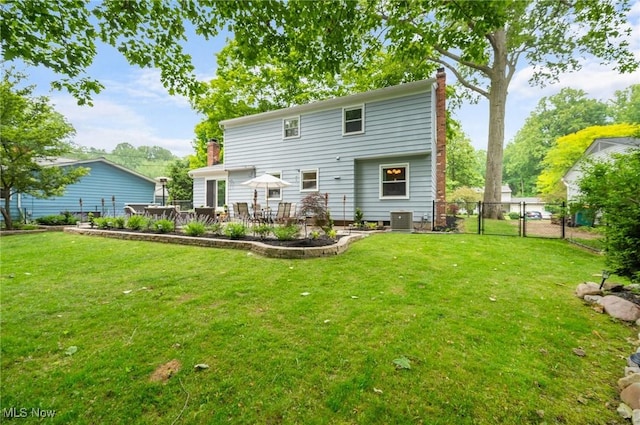 8222 Starburst Rd, Mentor, OH 44060 - rear view of property with a chimney, central AC unit, and a patio