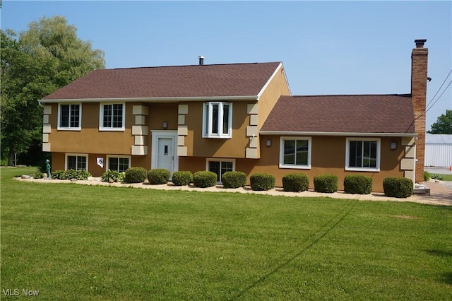 6019 New London Rd, Ashtabula, OH 44004 - view of front of home with a chimney, stucco siding, and a front lawn