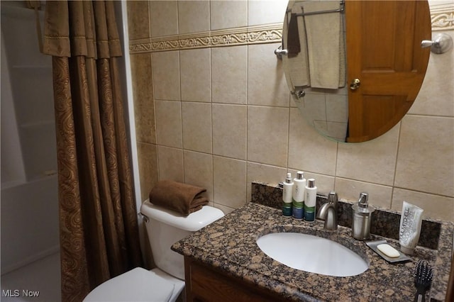 6019 New London Rd, Ashtabula, OH 44004 - full bathroom featuring tile walls, decorative backsplash, vanity, and shower / tub combo with curtain