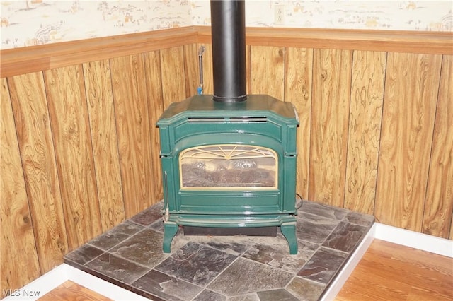 6019 New London Rd, Ashtabula, OH 44004 - detailed view of a wood stove, wooden walls, and wood finished floors