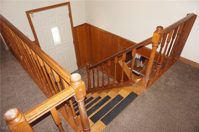 6019 New London Rd, Ashtabula, OH 44004 - stairway with a wainscoted wall, carpet, and wood walls