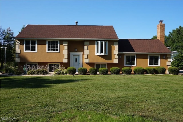 6019 New London Rd, Ashtabula, OH 44004 - view of front facade featuring a chimney, a front lawn, and stucco siding