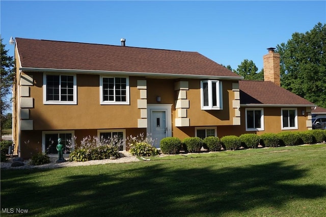 6019 New London Rd, Ashtabula, OH 44004 - raised ranch featuring a chimney, a front lawn, stucco siding, and a shingled roof