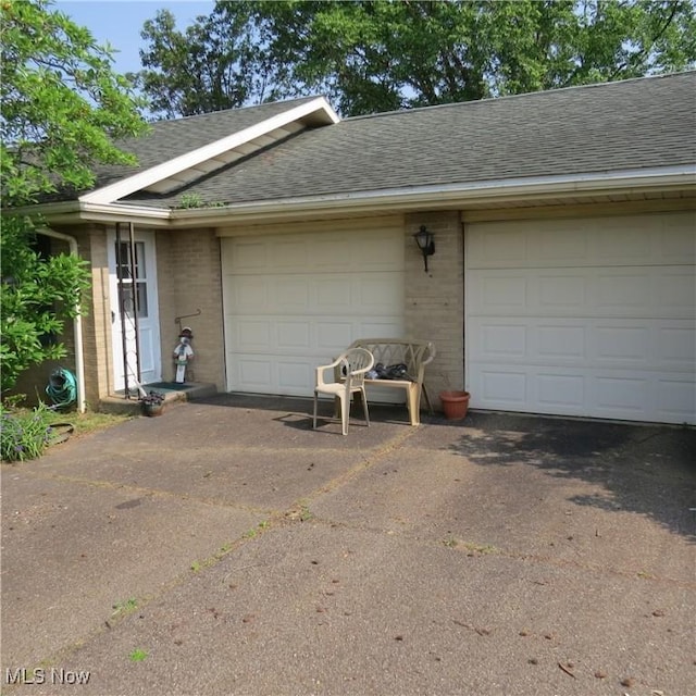 576 12th St NW, Carrollton, OH 44615 - garage featuring asphalt driveway