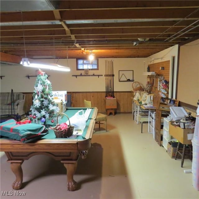 576 12th St NW, Carrollton, OH 44615 - rec room with finished concrete flooring, a wainscoted wall, and wood walls