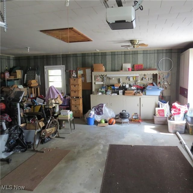 576 12th St NW, Carrollton, OH 44615 - garage featuring a garage door opener and a ceiling fan