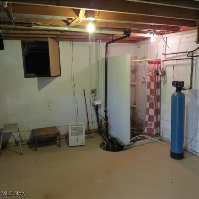 576 12th St NW, Carrollton, OH 44615 - unfinished below grade area with concrete block wall and a water softener