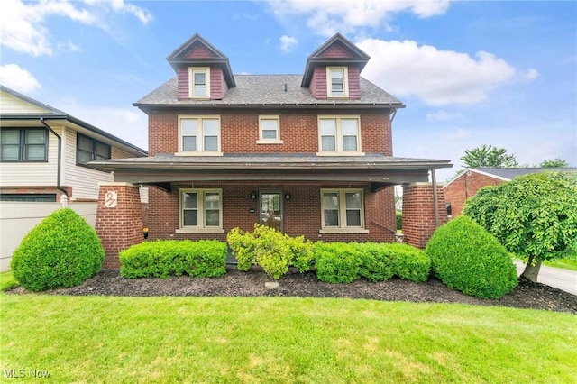 97 Overlook Blvd, Struthers, OH 44471 - view of front facade with brick siding, a front yard, a porch, and roof with shingles