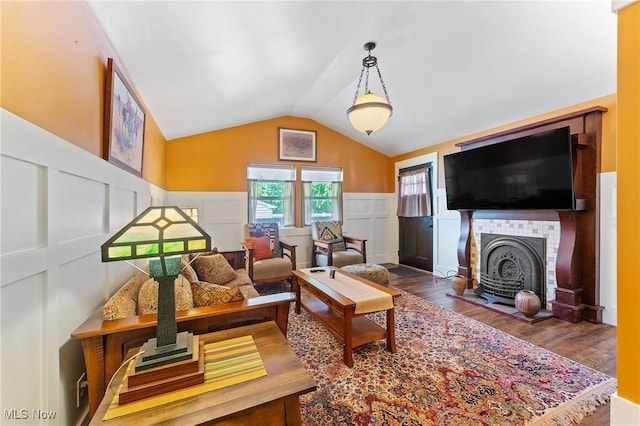 97 Overlook Blvd, Struthers, OH 44471 - living area with a wainscoted wall, wood finished floors, a tiled fireplace, and lofted ceiling
