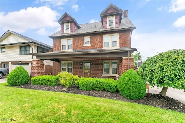 97 Overlook Blvd, Struthers, OH 44471 - view of front of house with brick siding, a front yard, covered porch, and an attached garage