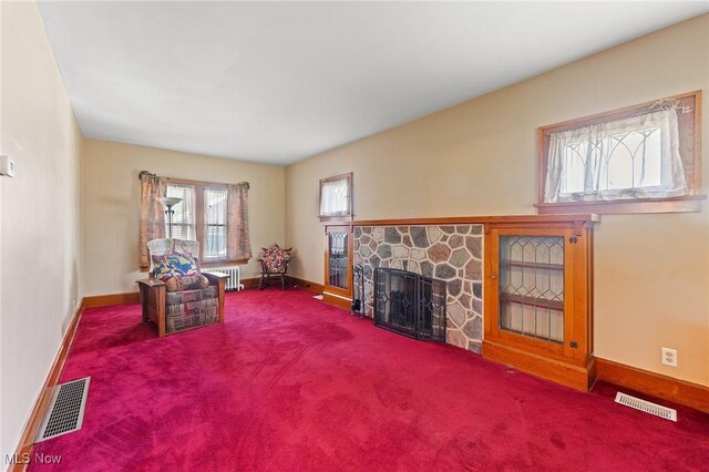 97 Overlook Blvd, Struthers, OH 44471 - living area with a fireplace, baseboards, radiator, and carpet
